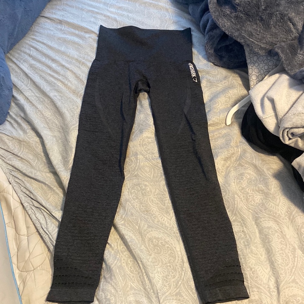 Dark grey gym shark leggings with hole detailing at the bottom.